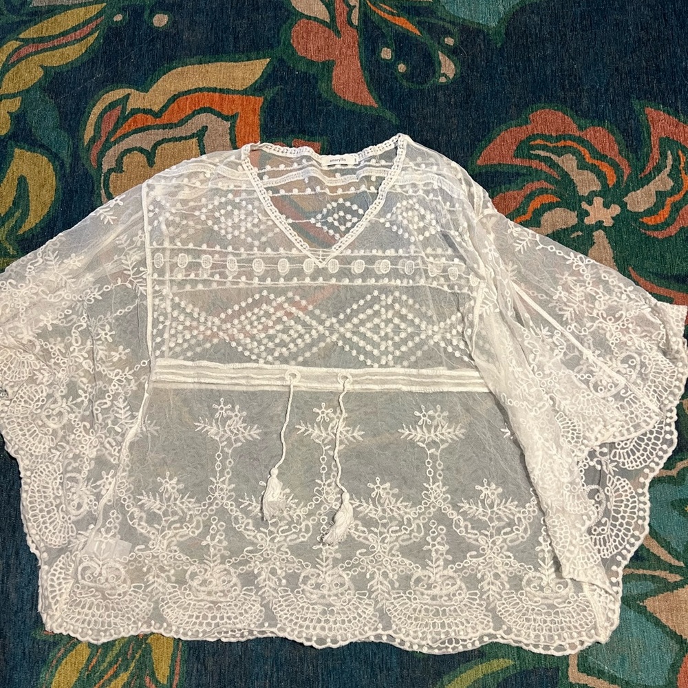 Amaryllis sheer top. One size fits most. Adjustable tie. I used as a cover up.